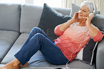 Buy stock photo Senior, woman and headphones on couch in house for meditation, retirement and relax. Happiness, zen and podcast on couch in living room for self care, mindfulness and spiritual audio on sofa.