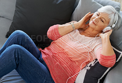 Buy stock photo Woman, senior and headphones on couch for relax, retirement and podcast in house. Happiness, wellness and peace on sofa in living room for self care, online and streaming for mindfulness and zen