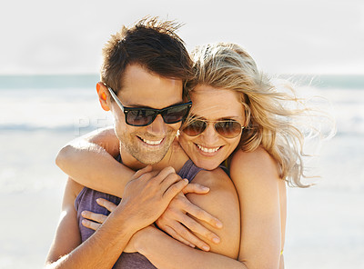 Buy stock photo Happy couple, hug and sunglasses at beach with sunshine for summer vacation, honeymoon and traveling. Man, smile and woman with eyewear at ocean for embrace, island holiday and together in Maldives