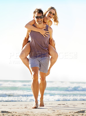Buy stock photo Man carrying wife on beach for vacation with love, marriage with trust and bonding. New Zealand couple by ocean with smile or hands for support, honeymoon with sunglasses for sunny day in Auckland