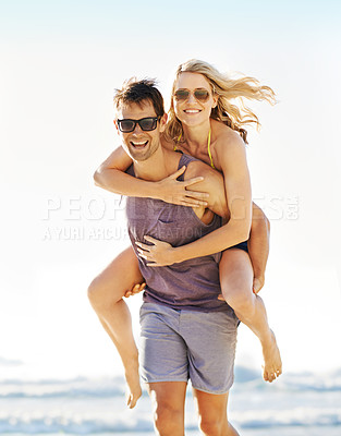 Buy stock photo Man carrying wife on beach for holiday with love, marriage with trust and bonding. New Zealand couple by ocean with smile or hands for support, vacation with sunglasses for sunny day in Auckland