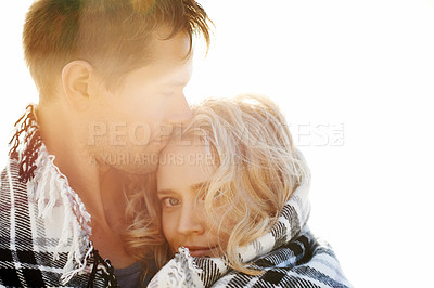 Buy stock photo A man placing a gentle kiss on his girfriend's head while they're wrapped in a blanket 