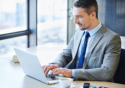 Buy stock photo Shot of a businessman working on a laptop in the office