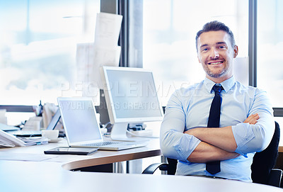 Buy stock photo Portrait of a smiling businessman sitting at his desk with his arms crossed