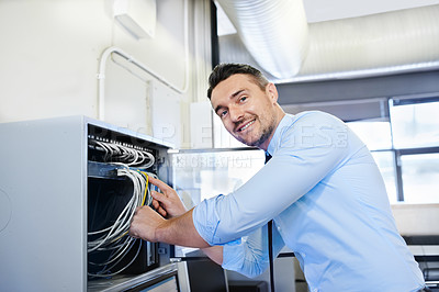 Buy stock photo Portrait of a smiling computer engineer working on a server