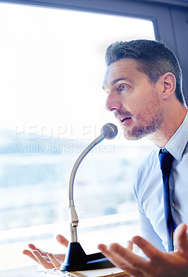 Buy stock photo Businessman, speech and presentation with mic for talk or discussion on podium at office. Man, politician or business spokesperson in conversation or political debate with speaker or desk microphone