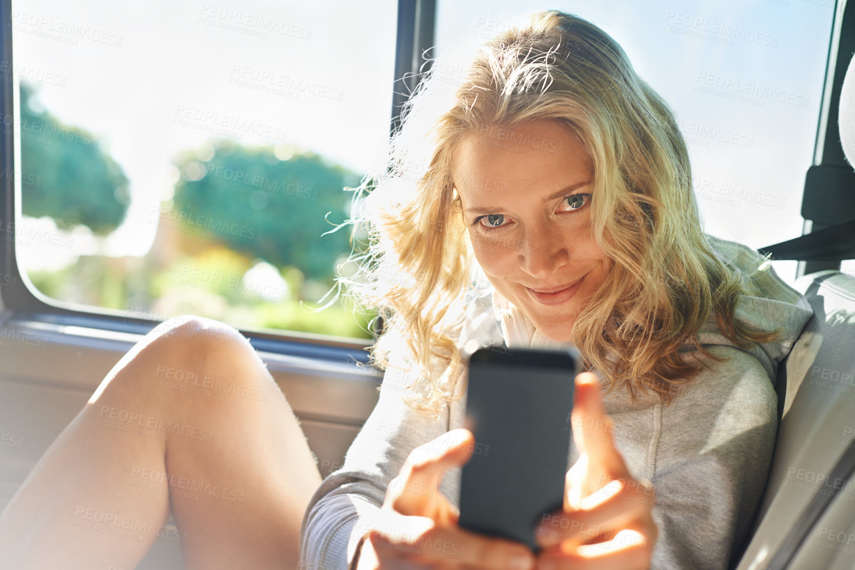 Buy stock photo Woman, portrait and smartphone in car for photo, memory and road trip while on vacation or travel. Female person, smile and phone in vehicle for picture, fun and adventure while on holiday in Arizona