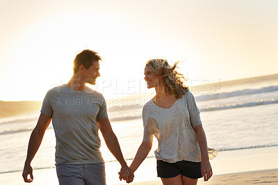 Buy stock photo Holding hands, smile and couple with love at beach, ocean and sea for affection, bonding or to relax. People, partners and romance for care together on vacation, holiday and travel in Australia