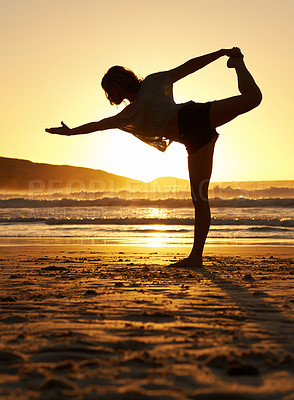 Buy stock photo Shot of a young woman doing yoga on the beach 