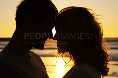 Buy stock photo Couple, love and kiss at ocean with sunset for date or summer holiday and bonding in Florida. Relationship, commitment and romance together as soulmate with smile, fun and vacation for honeymoon