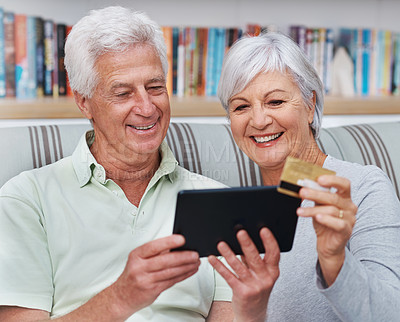 Buy stock photo Happy senior couple, tablet and credit card for online shopping on living room sofa together at home. Elderly man and woman smiling on technology for ecommerce, banking app or payment on lounge couch