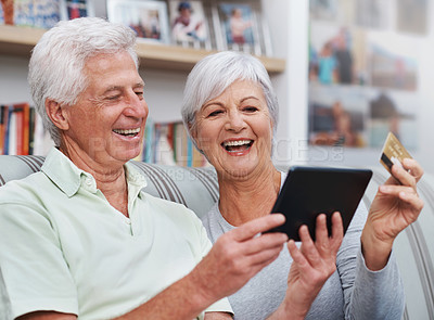 Buy stock photo Excited senior couple, tablet and credit card for online shopping on living room sofa together at home. Happy elderly man and woman smiling on technology in ecommerce, sale or payment on lounge couch