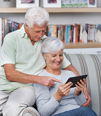 Buy stock photo Senior couple, tablet and home on couch for social media, online news app and reading ebook. Happy old man, elderly woman and digital technology for subscription show, internet connection and website