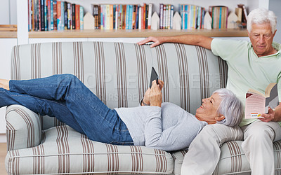 Buy stock photo Senior couple, tablet and laugh for bonding in home, comedy and streaming comic on social media. Elderly people, funny internet blog and reading on couch, book and happy in retirement for online love