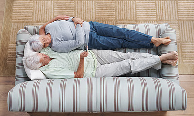 Buy stock photo Top view, tablet and senior couple relax on sofa, social media and online app for ebook at home. Happy old man, woman and digital technology subscription, streaming and website on internet connection