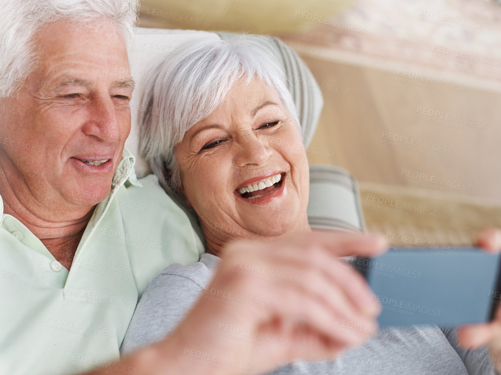 Buy stock photo Happy senior couple, selfie and relax on sofa in living room with smile for photo, memory or profile picture at home. Elderly man and woman smiling for photograph, vlog or social media on couch