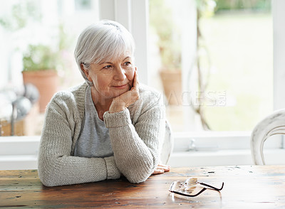 Buy stock photo Senior woman, home and thinking of nostalgia, memory and relaxing retirement with hope for vision at table. Happy elderly grandma daydream of history, aging process and wisdom of thoughtful memories