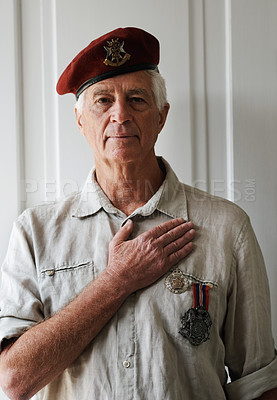 Buy stock photo Mature man, war and veteran in retirement with service, medals and uniform as soldier or patriot. Senior person, army and hero in portrait for memories, pride and respect in home with hand on heart