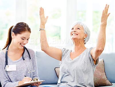 Buy stock photo A doctor explaining positive test results to an overjoyed senior patient