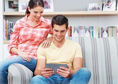 Buy stock photo Couple, home and smile with tablet on sofa for social media, networking and entertainment. People, couch and living room on internet or online with streaming platform for videos, fun and memes