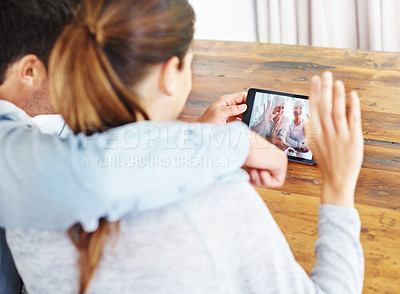 Buy stock photo Couple, tablet and video call with grandparents for online conversation or greeting at home. Rear view of man and woman talking or waving with technology for virtual meeting, talk or communication
