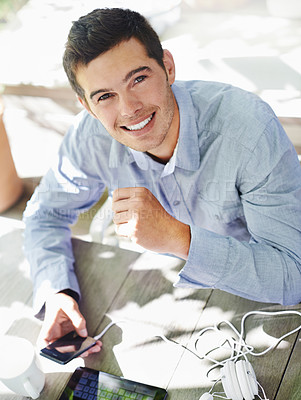 Buy stock photo Smile, table and portrait of man with phone for online networking, communication and social media. Happy, male person and high angle with technology in garden for website, streaming and information