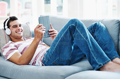 Buy stock photo Sofa, headphones and portrait of man with tablet for online video, subscription and watching movie. Happy, relax and male person with digital technology at home for network, connectivity or streaming