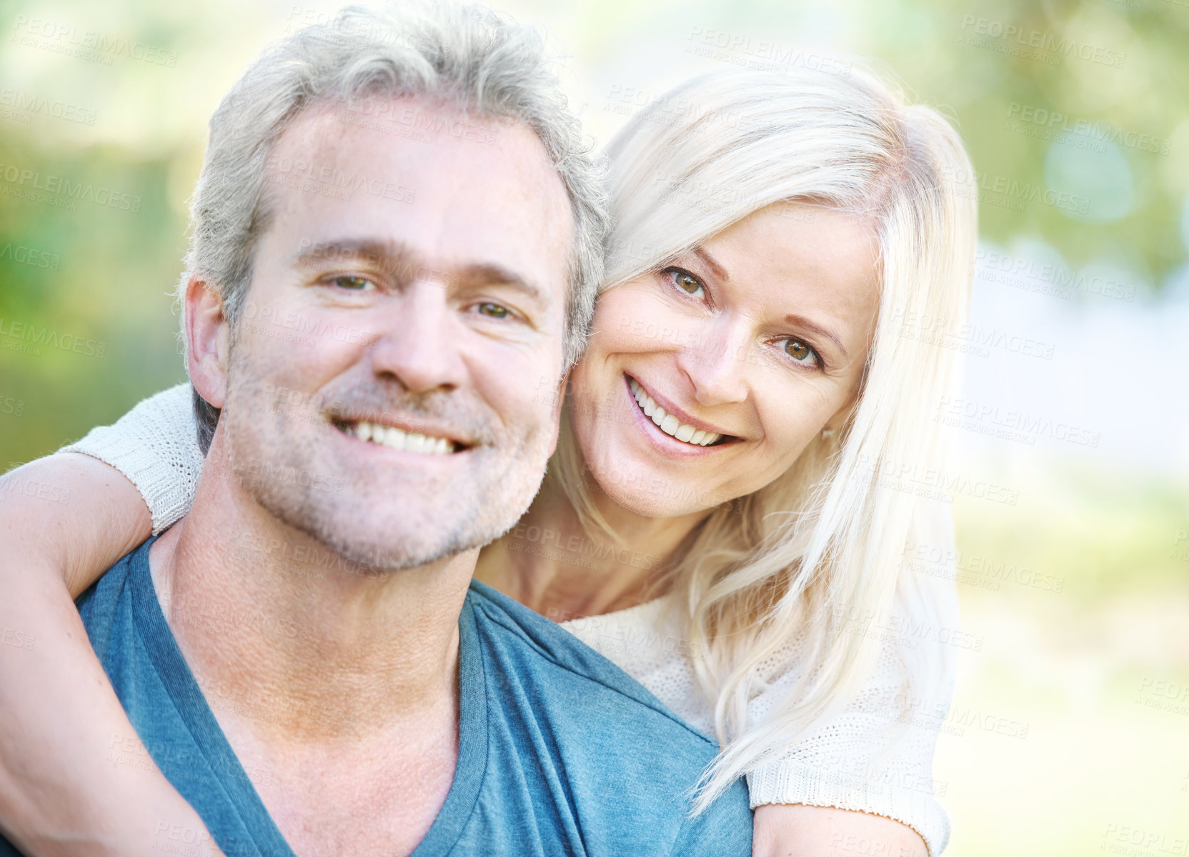 Buy stock photo Portrait of a mature woman hugging her handsome husband