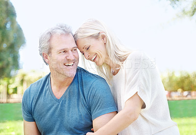 Buy stock photo Happy, hug and senior couple in park for bonding, relationship and commitment outdoors on weekend. Love, retirement and mature man and woman embrace for romance, relaxing and marriage in nature