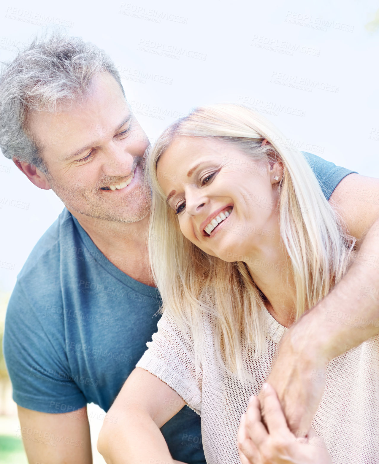 Buy stock photo An affectionate mature couple enjoying a day in the park together