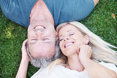 Buy stock photo Mature, happy couple and outdoor relax on grass from above for marriage anniversary, travel or relationship. Man, woman and top view in garden park in New Zealand for holiday trip, peace or nature