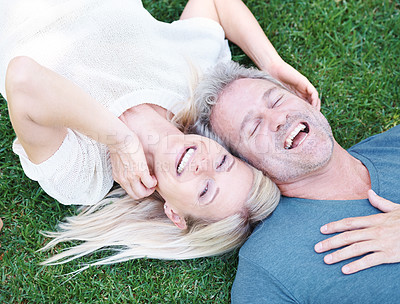Buy stock photo Man, woman and mature or laughing outdoor on grass field for funny joke or comedy, connection or top view. Happy couple, relax and backyard in Australia for relationship bonding, nature or together