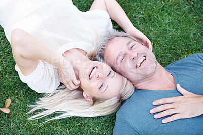 Buy stock photo Man, woman and mature or laughing in nature on grass field for funny joke or comedy, connection or top view. Happy couple, relax and backyard in Australia for relationship bonding, park or marriage