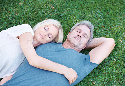 Buy stock photo Happy couple, relax and sleeping on grass field with love for embrace, care or support in nature. Top view of man and woman asleep on lawn above with hug for cuddle or relaxation in outdoor romance