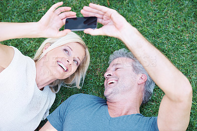 Buy stock photo Mature, couple and selfie smile on grass from above in garden backyard for social media post, memory or travel. Man, woman and happiness for profile picture from holiday trip, vacation or connection