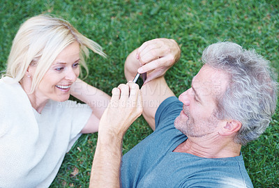 Buy stock photo Mature, couple and cellphone picture in nature for relationship memory, photography or grass. Man, woman and smartphone photo of wife in backyard with holiday travel in Florida, relax or marriage