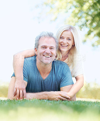 Buy stock photo Portrait of a mature man enjoying his wife's affections in the park