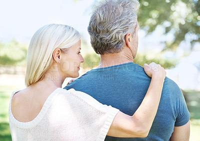 Buy stock photo Rear-view of a mature couple looking away while standing outdoors