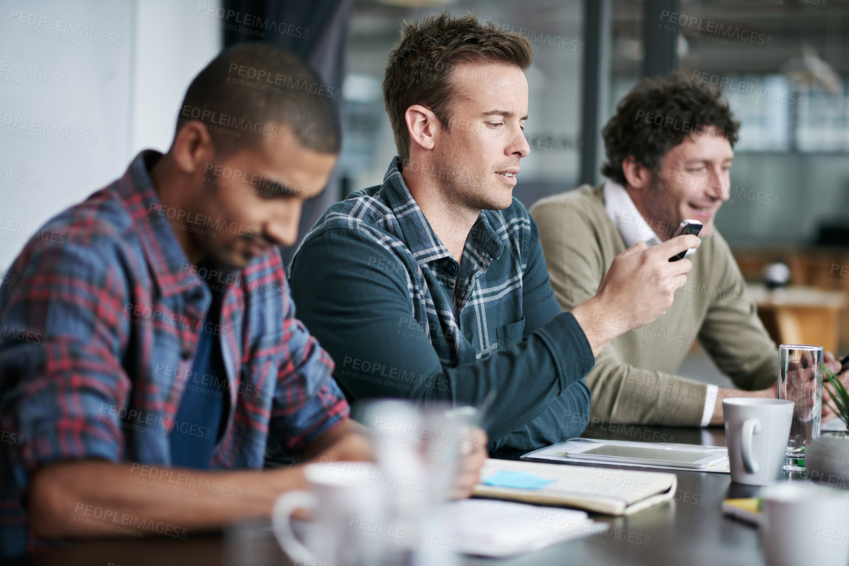 Buy stock photo Boardroom, phone and men in meeting, smile and strategy for business in social media and research. Creative, collaboration and teamwork with internet in mobile, ideas and project for copywriting