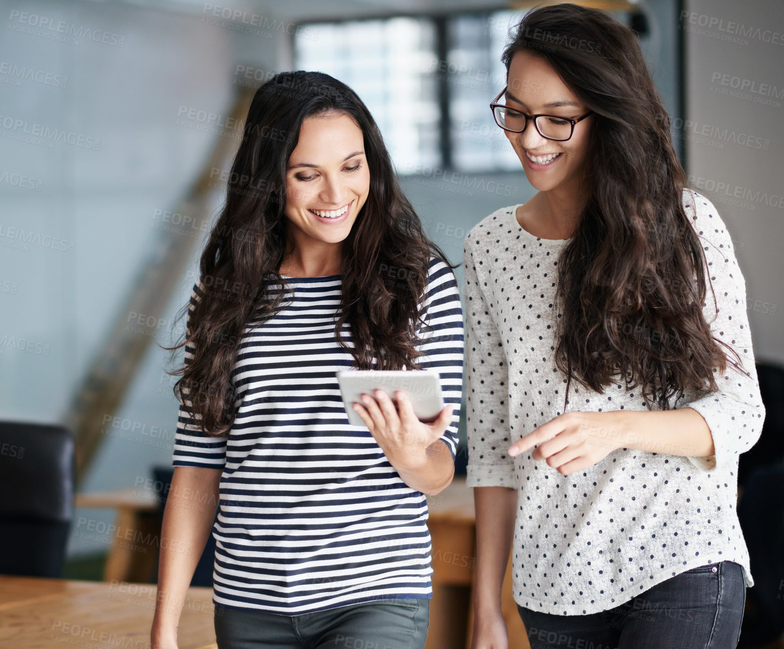 Buy stock photo Happy, team and women with digital tablet in a modern office for social media, meme or browsing while talking. Work, friends and females online for streaming, funny and sharing web comedy or joke