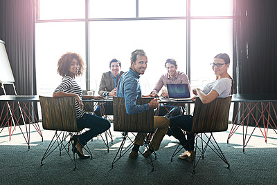 Buy stock photo Portrait of a group of office colleagues sitting around a boardroom table