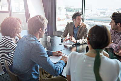 Buy stock photo Shot of a group of coworkers having a brainstorming session in an office boardroom