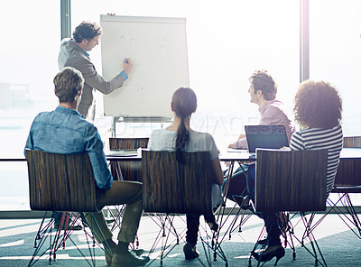 Buy stock photo Shot of a group of coworkers sitting in on a presentation in a boardroom