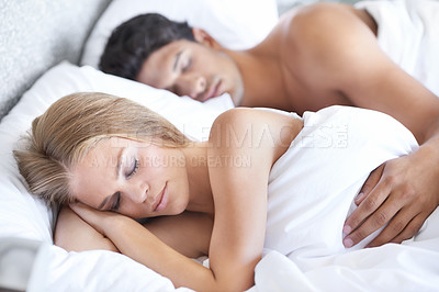 Buy stock photo Peace, sleeping and tired couple in bed with love, safety and security, comfort and bonding at home. Relax, sleep and people in bedroom for calm nap, snooze or lazy morning, dream or rest in house