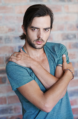 Buy stock photo Man, portrait and casual fashion by brick wall with pride, confidence and tshirt for style in Germany. Male person, contemplating and edgy model in trendy outfit for aesthetic
 and designer clothes