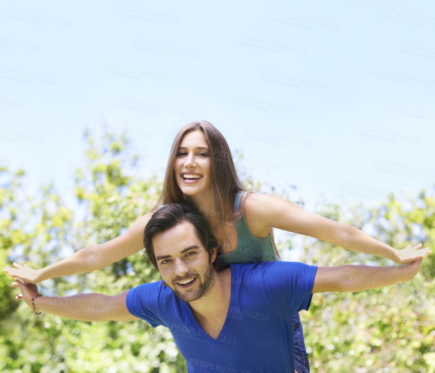 Buy stock photo Couple, piggy back and outside together for relationship, bonding love and care in nature date for romance. Blue sky, trees and summer holiday with airplane game for travel adventure in sunshine