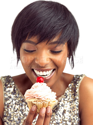 Buy stock photo Happy, woman and excited with cupcake in studio for sugar treat, sweet snack and junk food. Cherry, frosting and female person with cake for unhealthy, dessert and nutrition on white background