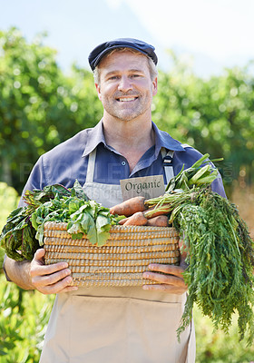 Buy stock photo A happy farmer holding a basket of vegetables