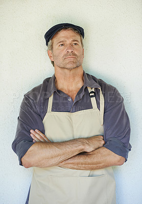 Buy stock photo Serious, man or farmer in apron with arms crossed thinking about harvest, agriculture and crop yield. Male person, idea and sustainable agro with uniform for gardening or farming isolated in studio