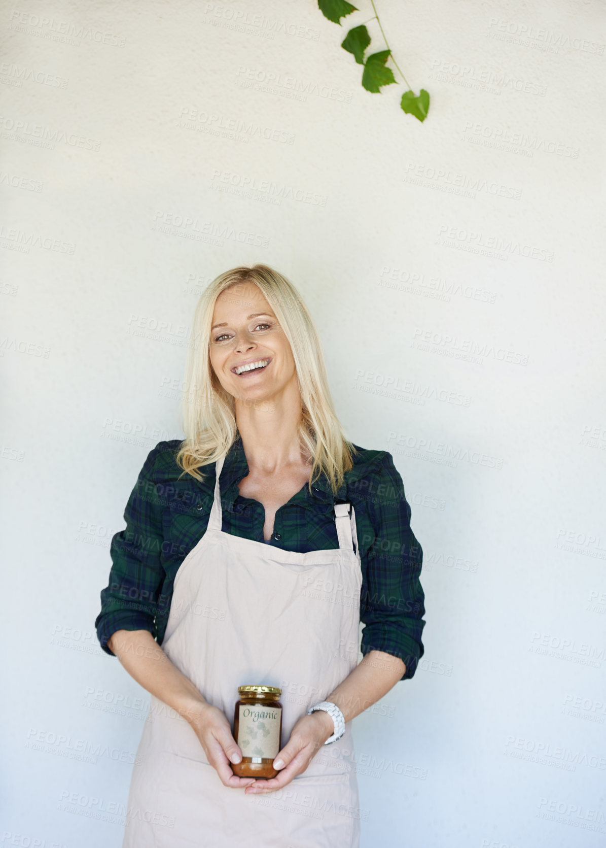 Buy stock photo Cropped shot of a person holding a jar of freshly made jam